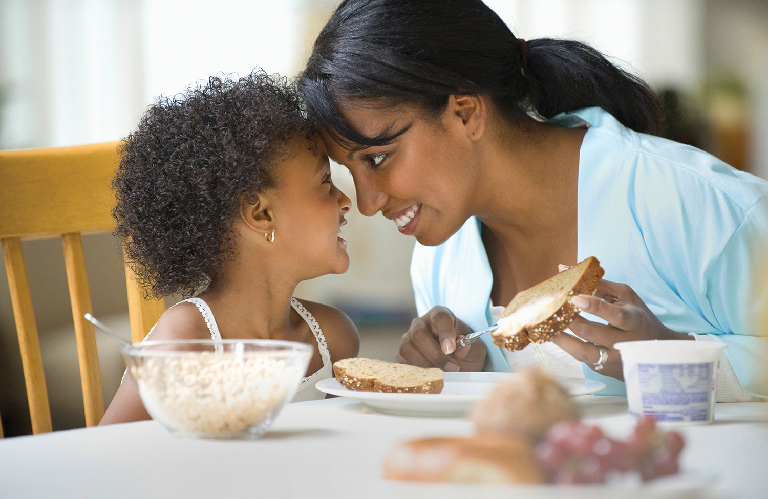 young girl smilng with her mom