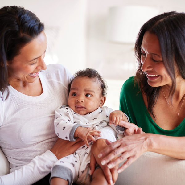 Two mothers with their baby